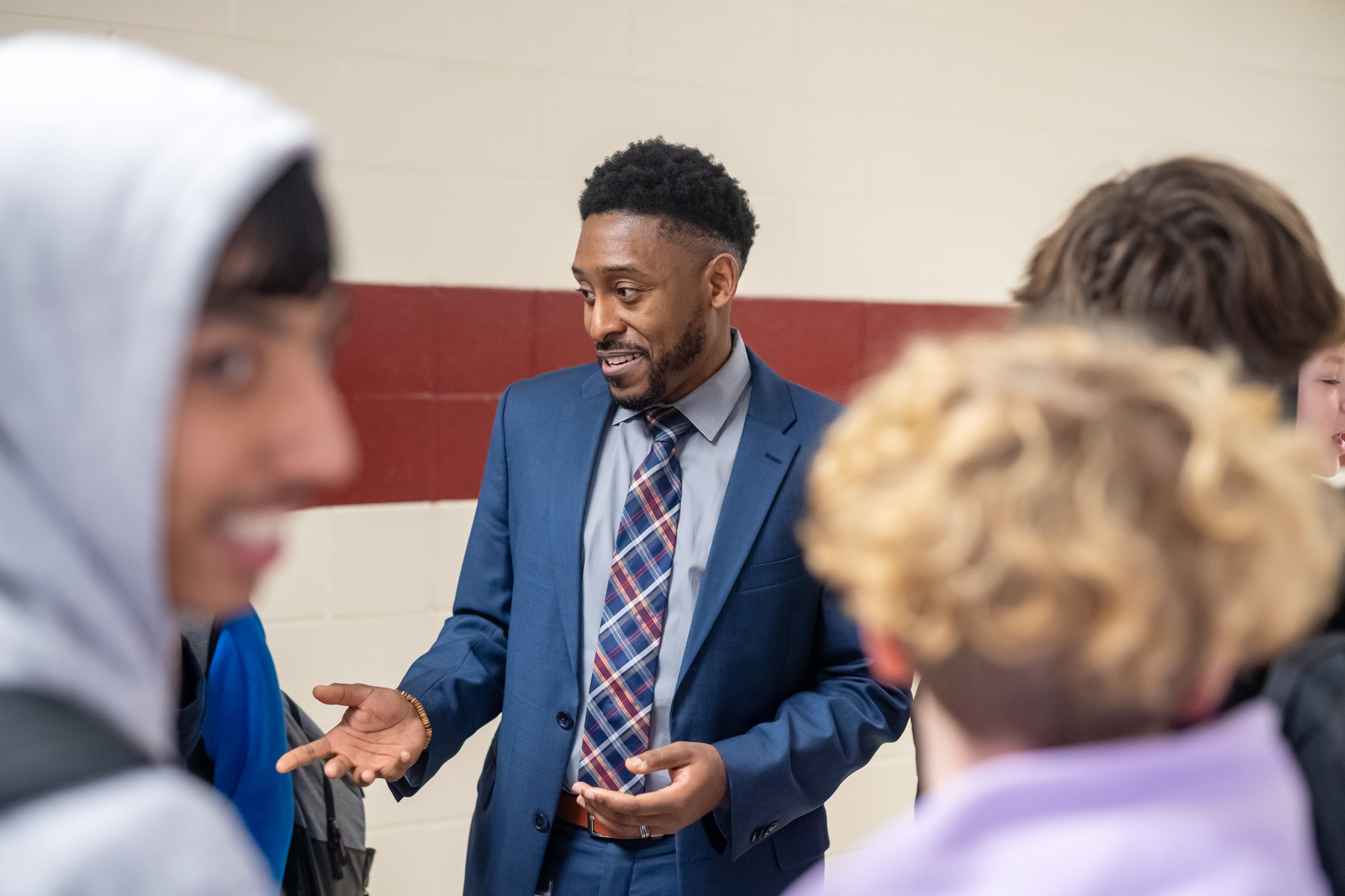 Principal greeting students